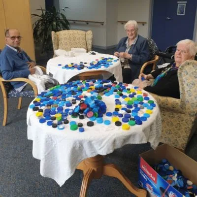 Aged-care residents sorting plastic lids for recycling. Lid Collection.