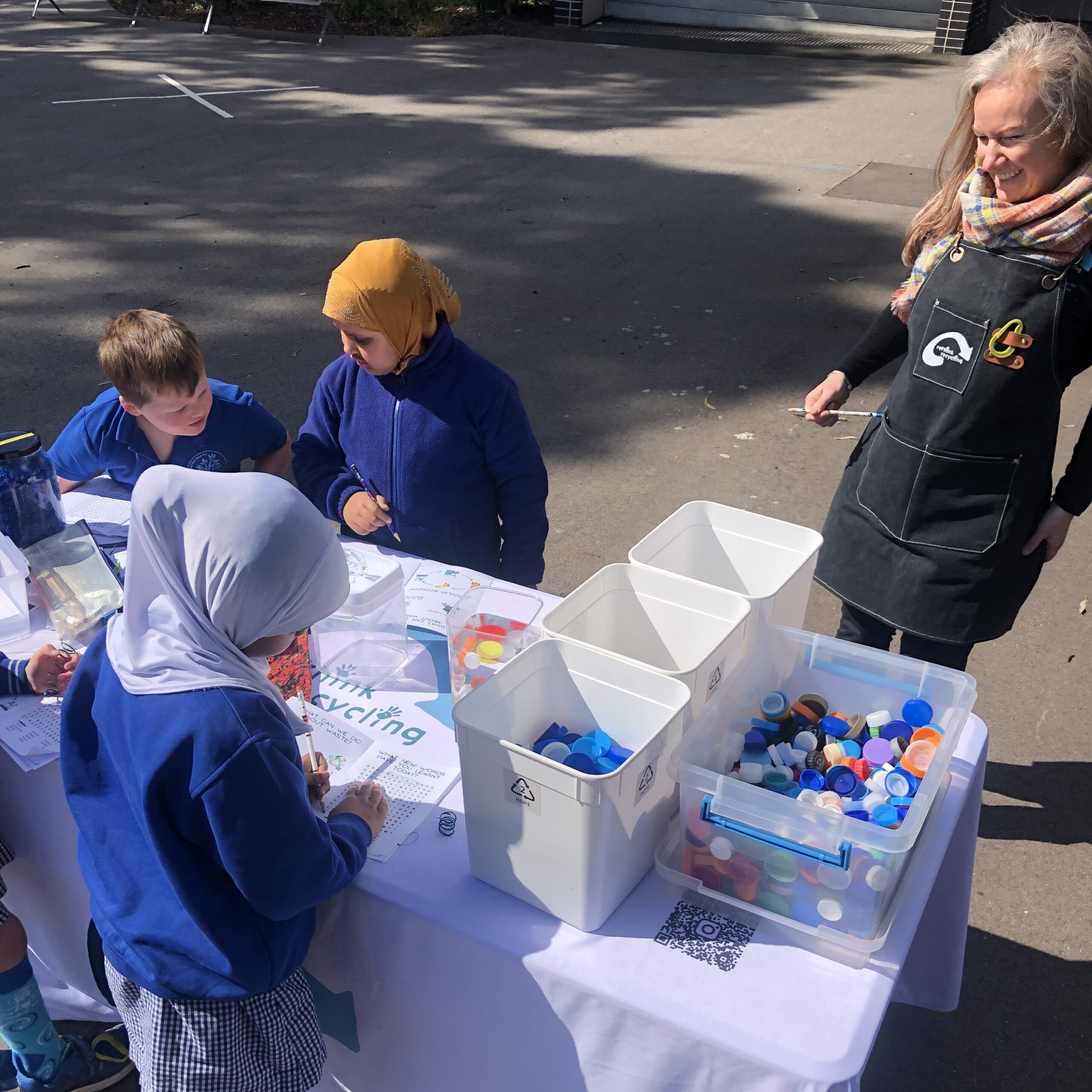 Primary students sorting plastic lids for recycling. Lid Collection.